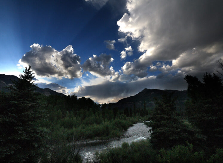 Fabulous crepuscular rays and clouds over a high altitude river and canyon near the Continental Divide in SE Colorado. Jerry and Lois Photography