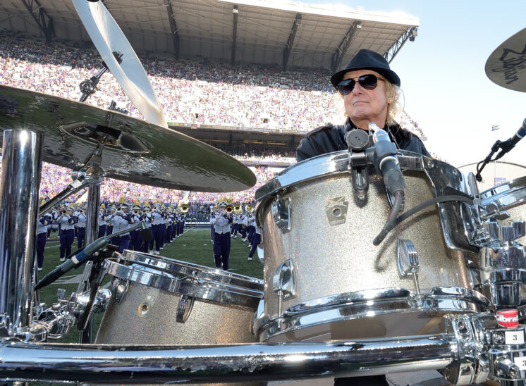 Alan White, world-class drummer for YES, John Lennon/Imagine, George Harrison/My Sweet Lord, and Rock and Roll Hall of Fame inductee being honored by the UW Husky Marching Band during their halftime show. © Jerry and Lois Photography